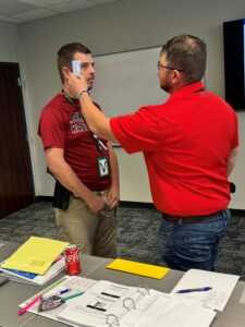 This photo illustrates an officer administering a DRE test on a test subject.